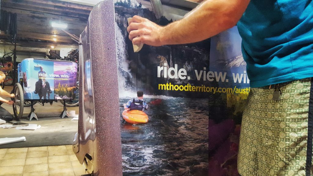 The Movemint team installing  Mt. Hood Territory ads on the Tipke fleet. 