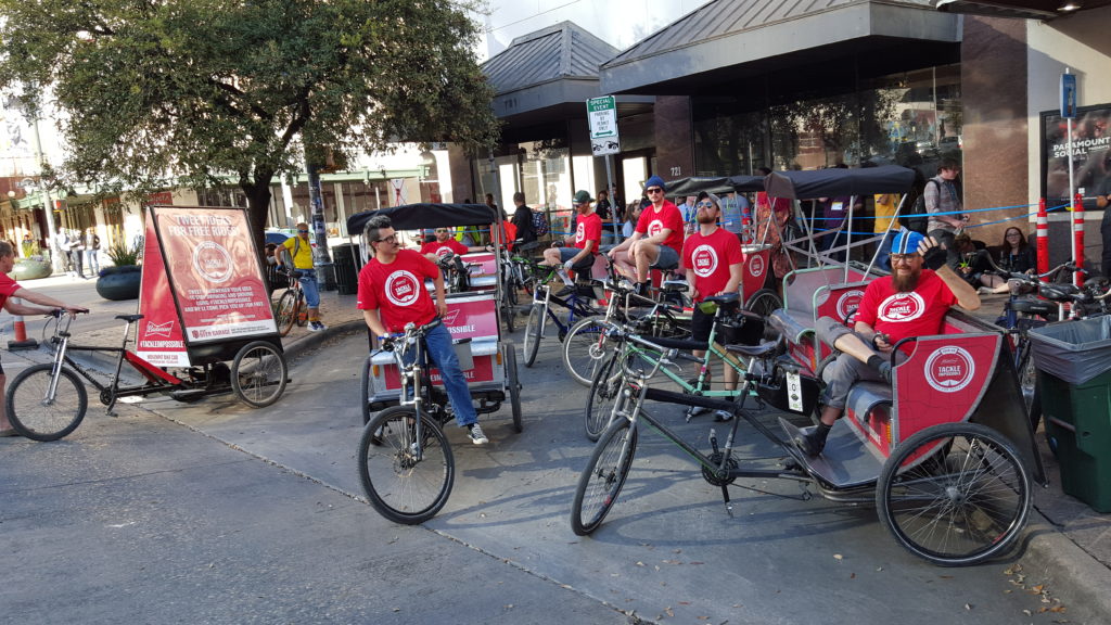 Pedicabs and sign trikes on the scene. Ready to give out free rides next to a active venue during SXSW.