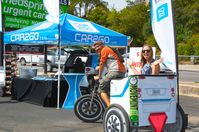 Andy giving a ride to a happy customer on a Car2Go wrapped pedicab during Austin City Limits ACL music festival